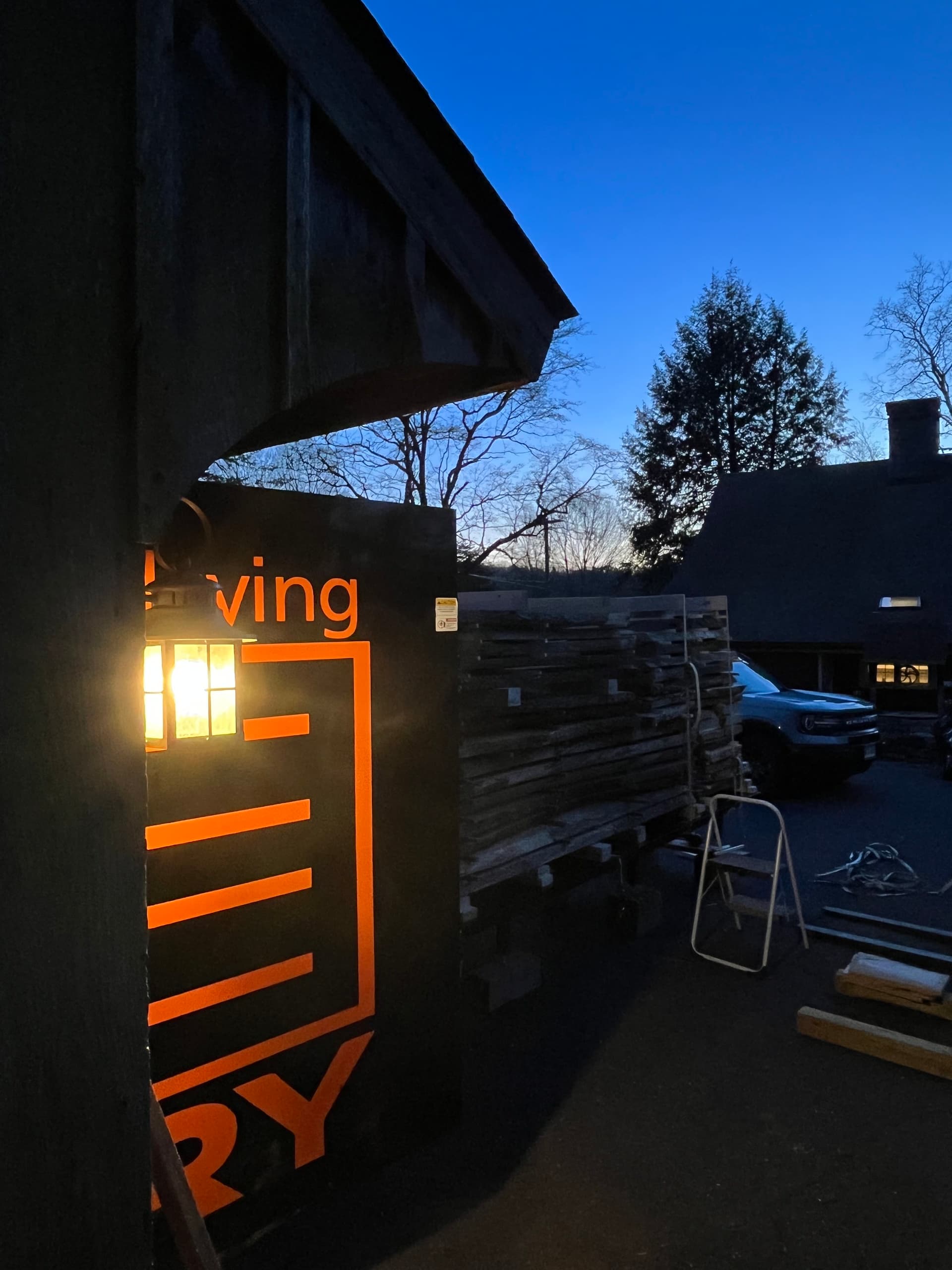 Kiln exterior with branded sign at dusk, showing the setup in the shop yard