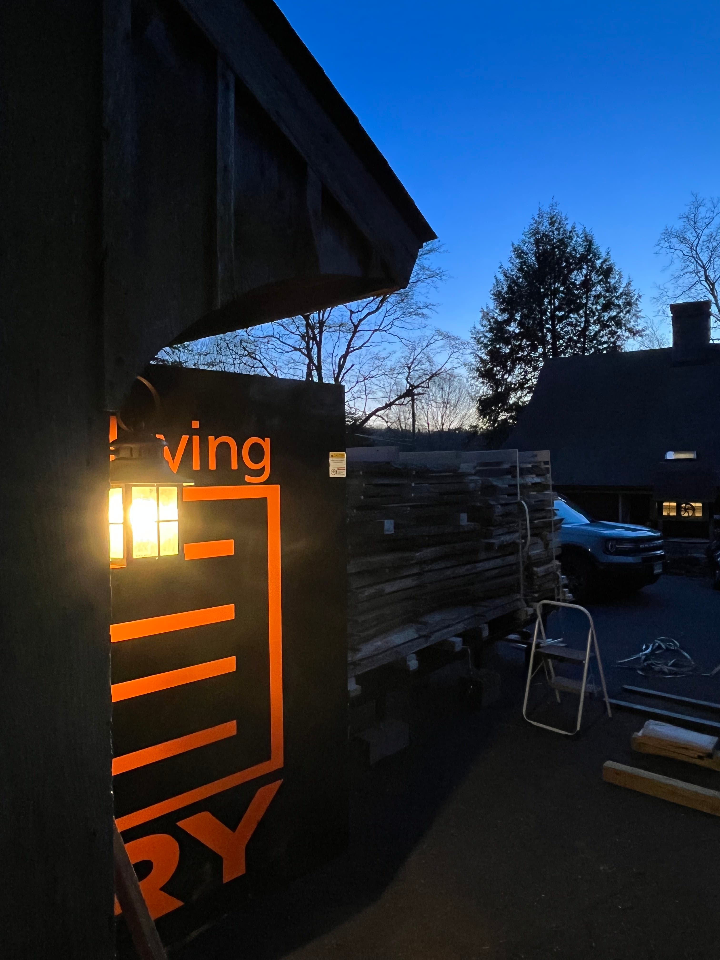 Kiln Exterior Sign At Dusk | Tougas Timberworks Monroe CT