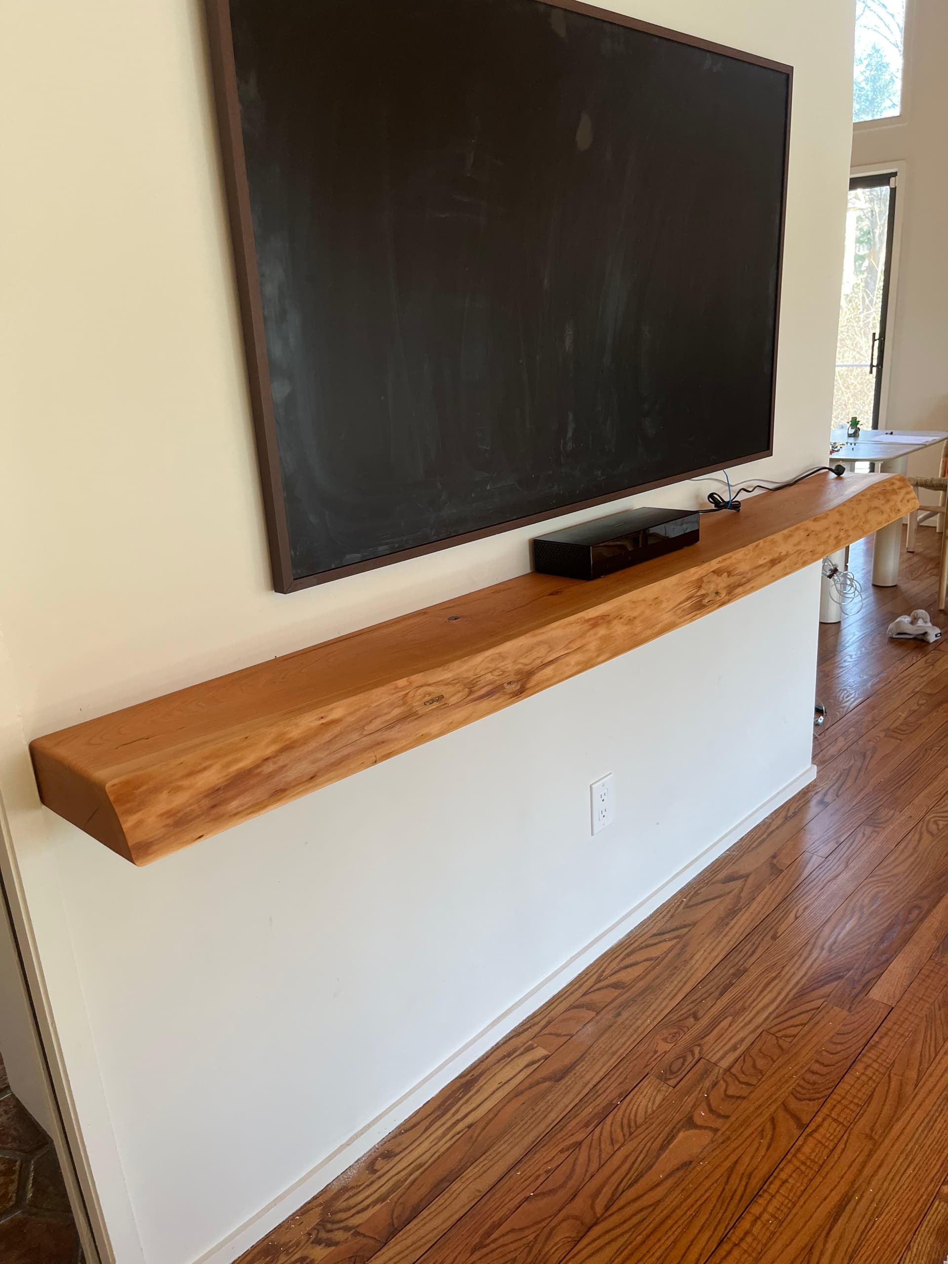 Live edge beam laid out on the workbench in the Monroe shop before mounting