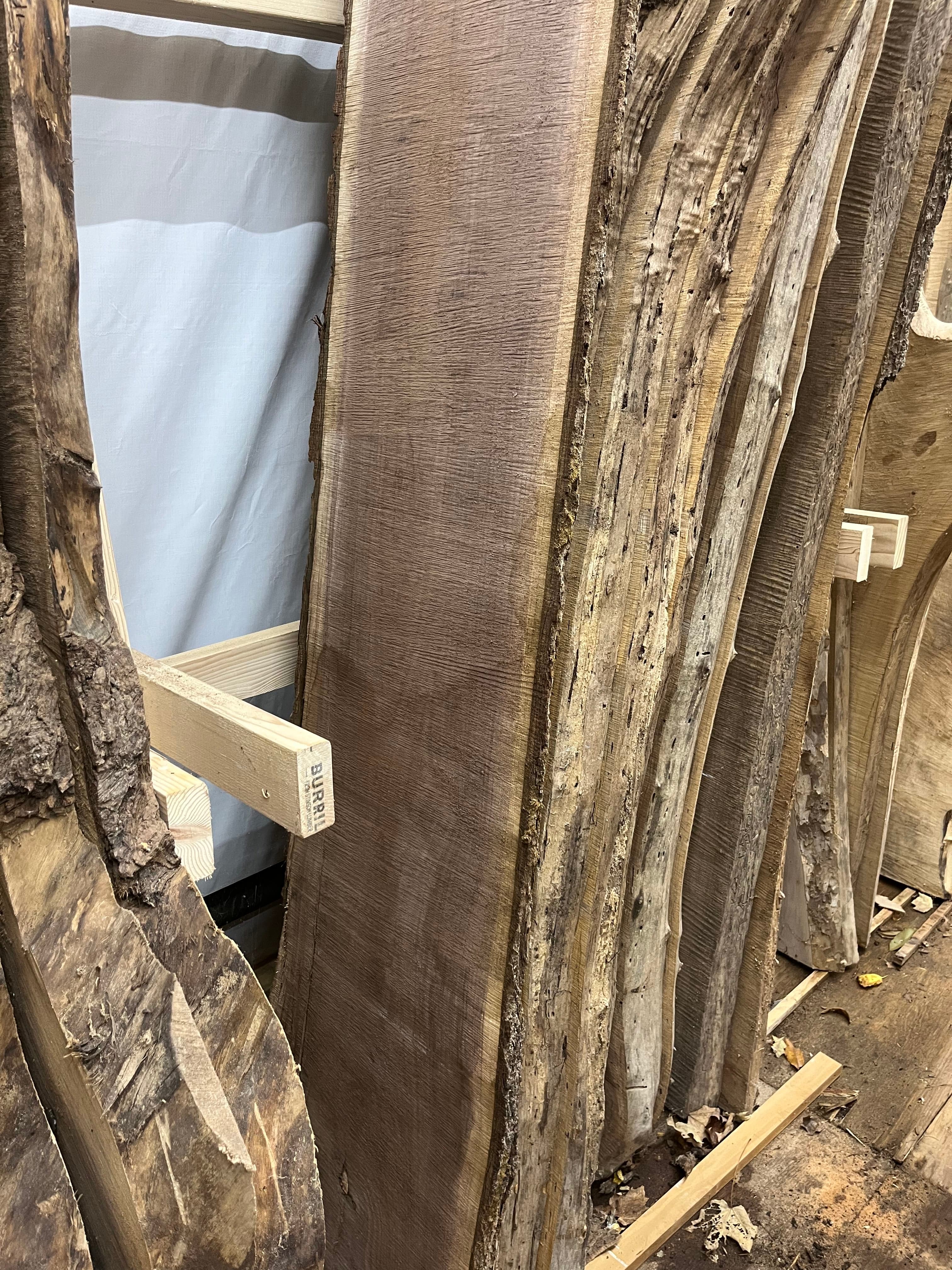 Slabs Stacked Overhead In Shop Dark | Tougas Timberworks Monroe CT