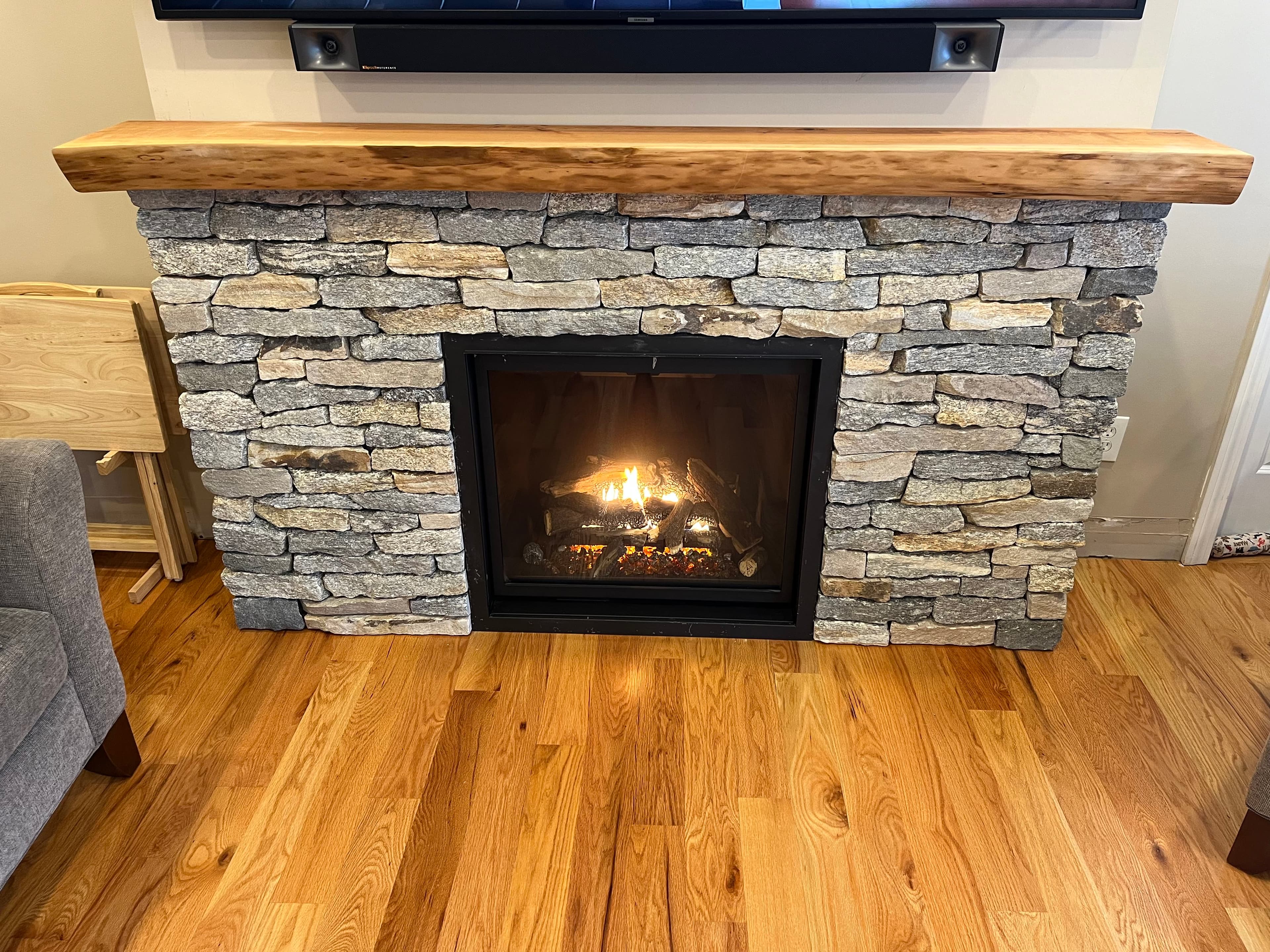 Stone Fireplace Live Edge Mantel Lit | Tougas Timberworks Monroe CT