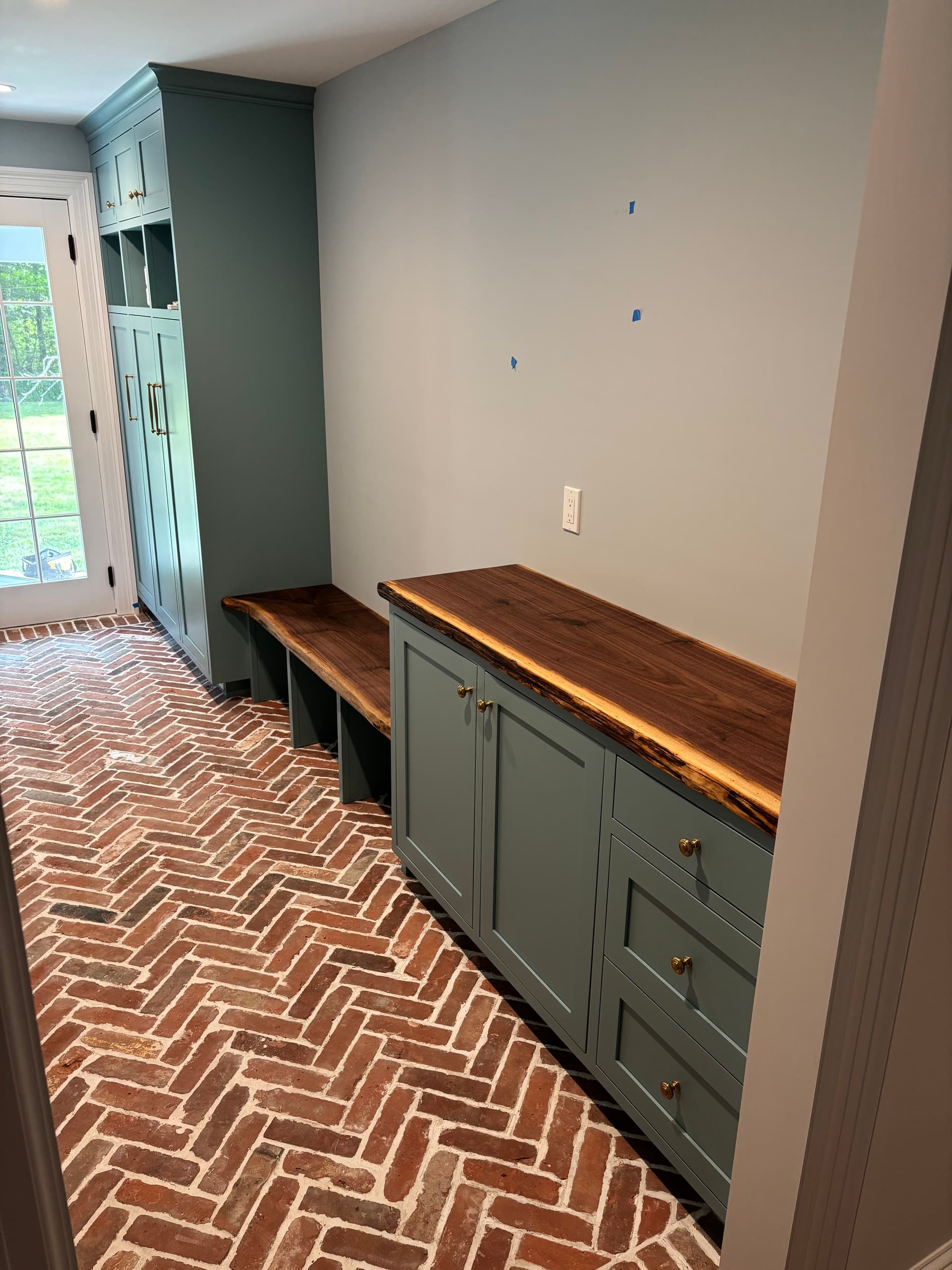 Custom walnut mudroom bench and cabinet built by Tougas Timberworks in Monroe, CT