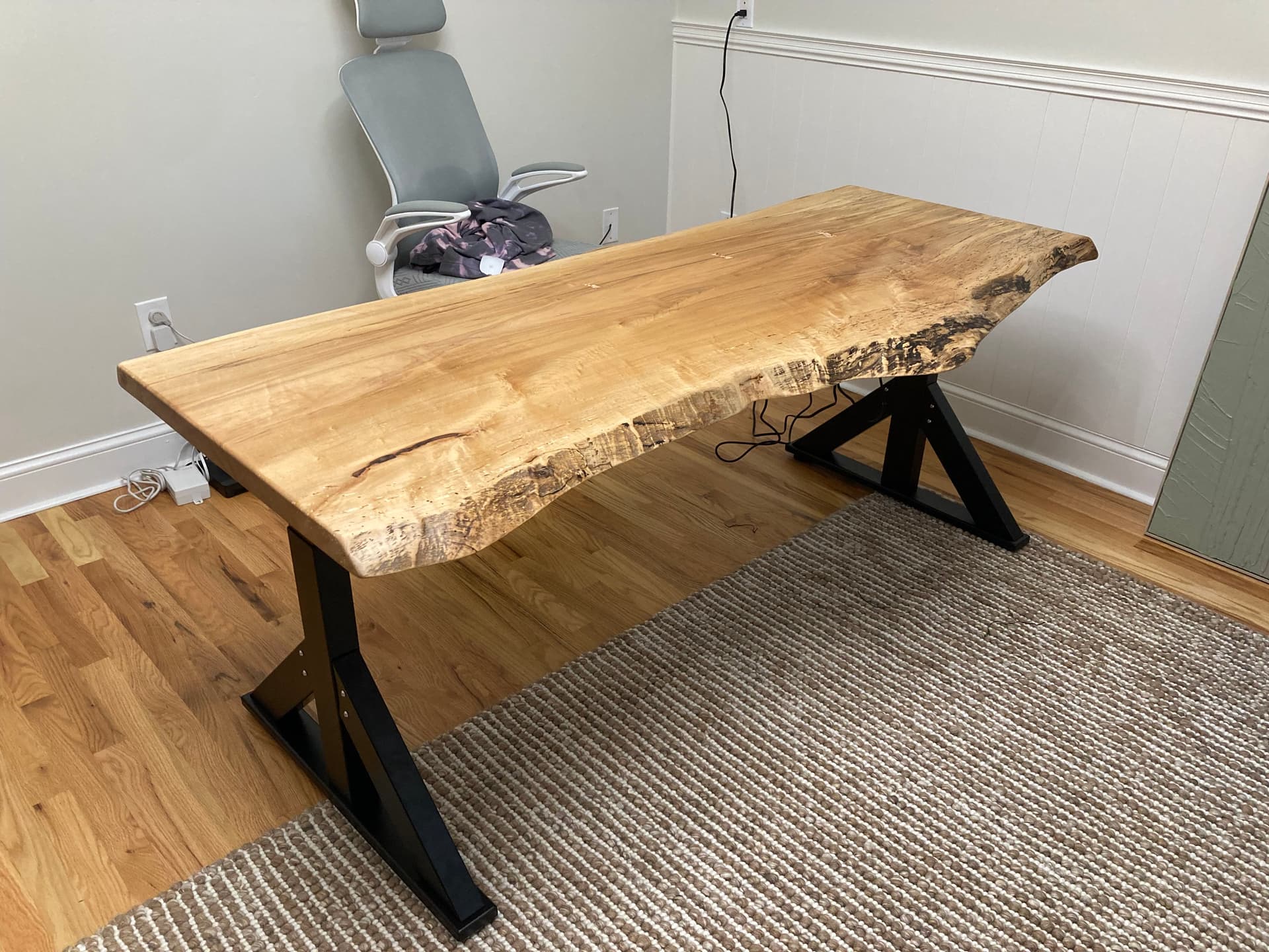 Underside of a live edge floating wall shelf showing the clean hidden mount